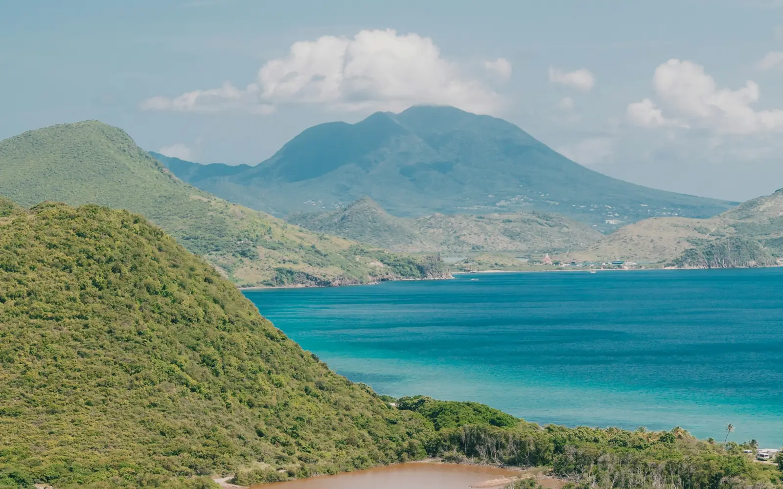 Nevis Peak seen across the sea from the green hills of St. Kitts